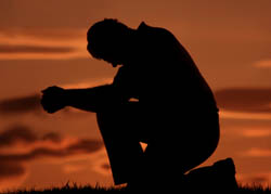 man-praying-on-one-knee