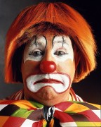 The author, who suffers from coulrophobia, (fear of clowns), describes a cross country plane journey with a depressed clown.